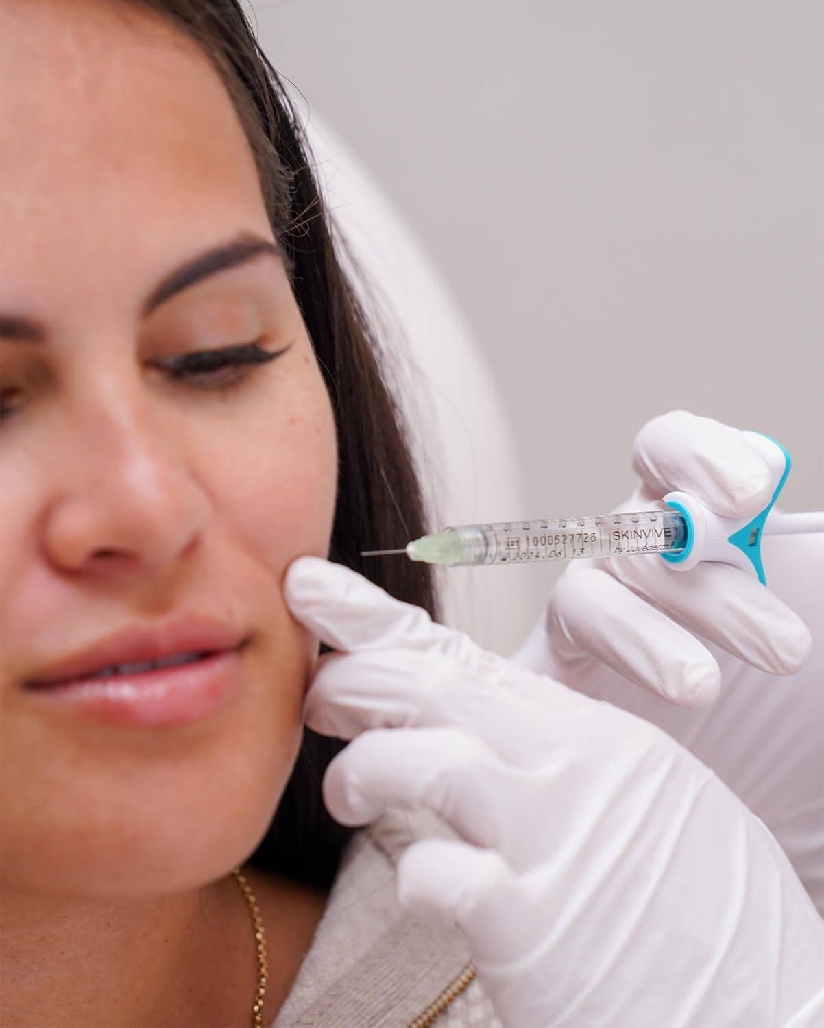 A person receiving an injection on the cheek