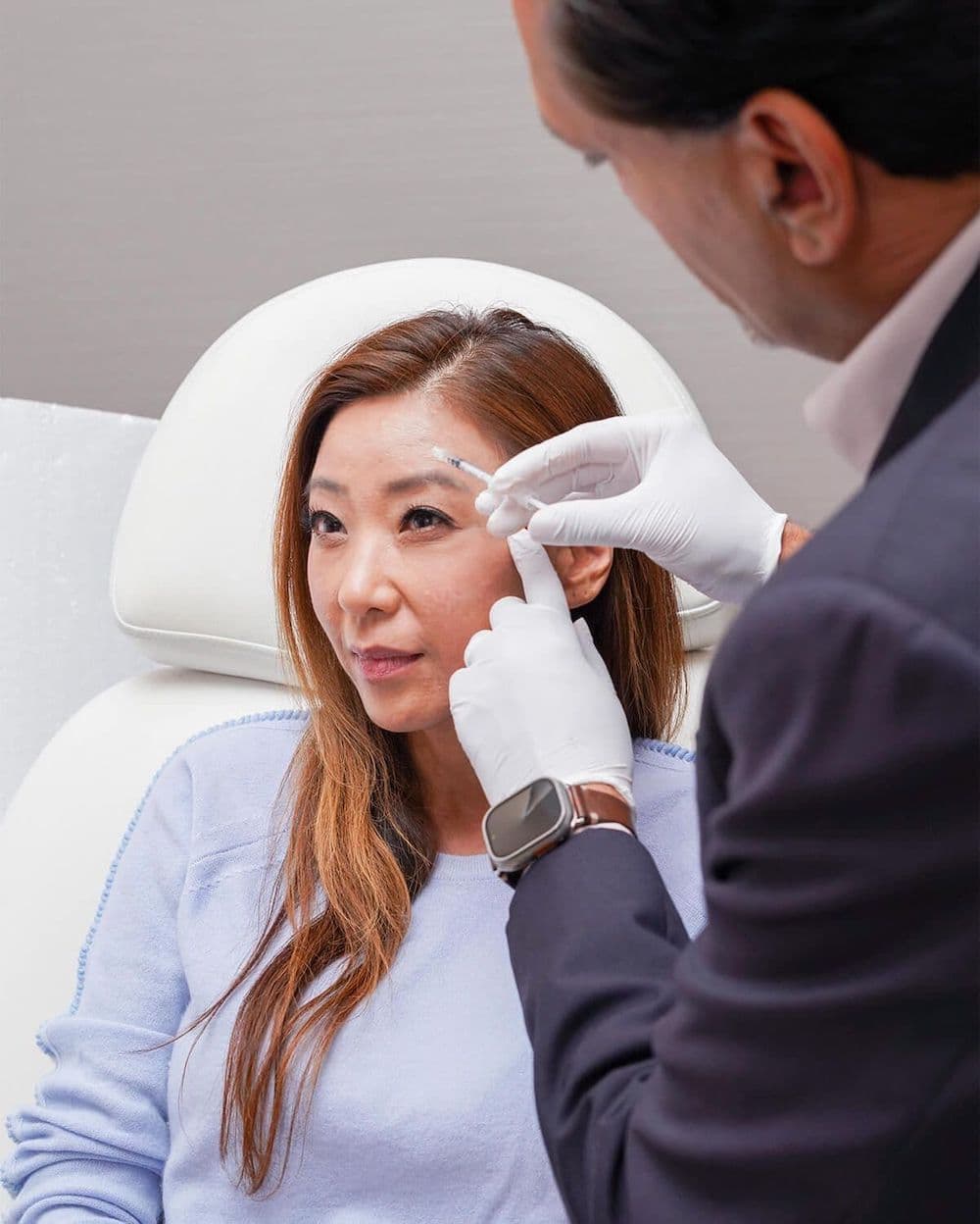 Woman receiving an injection on her face