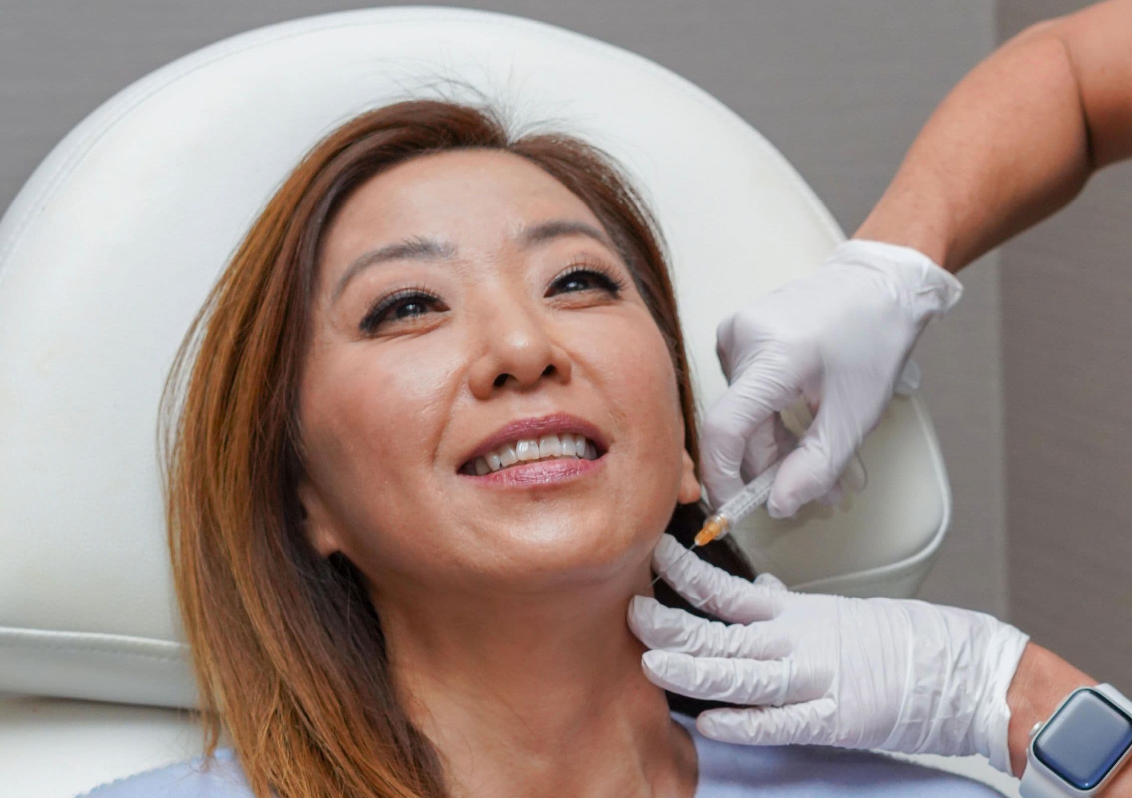 Woman receiving Radiesse neck injection